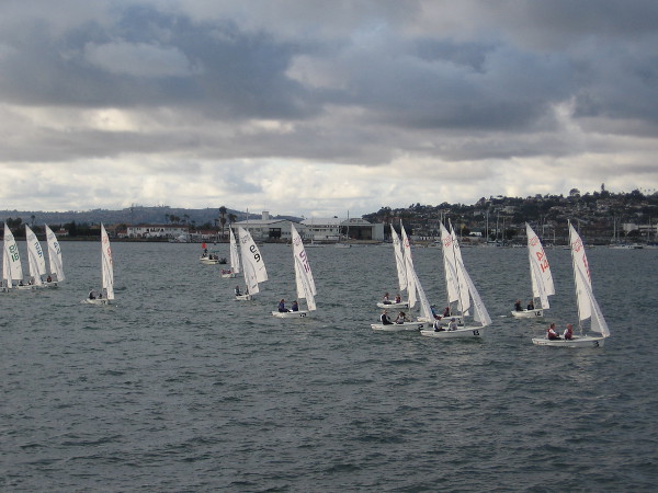 The San Diego Yacht Club sailboats approach the Embarcadero, having just passed the finish line.