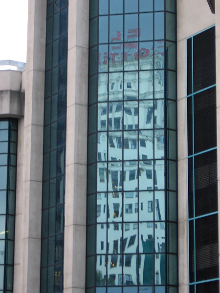 Reflection in glass panes of the Parking Palace shows the iconic sign atop the El Cortez.