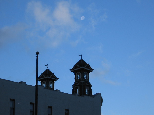 Photo of moon, high above towers of Louis Bank of Commerce Building's facade, one block over on Fifth Avenue. This famous location was home to Wyatt Earp's Oyster Bar gambling hall and saloon.