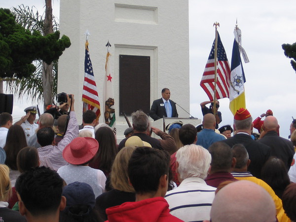 The color guard comes forward. Those attending the ceremony sing the Star Spangled Banner and say the Pledge of Allegiance.