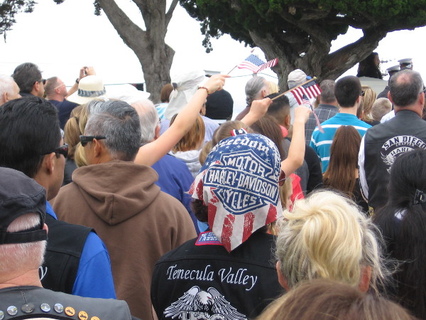 Some patriots in the crowd wave small flags.