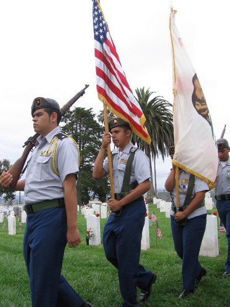 Members of a high school ROTC program carry the United States and California flags.