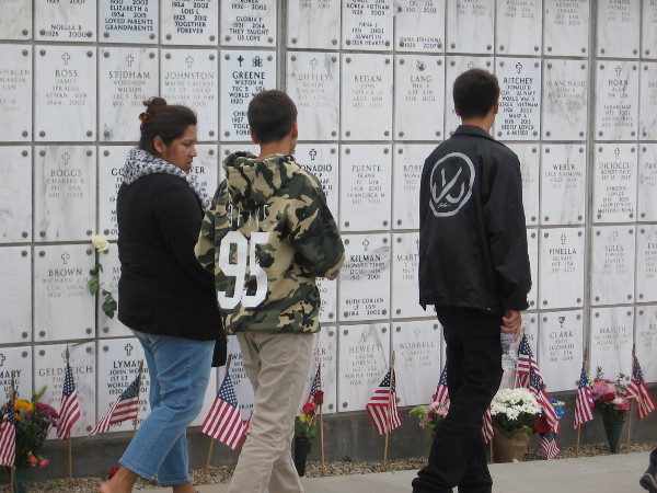 Walking along the columbarium. Its plaques identify loved ones.