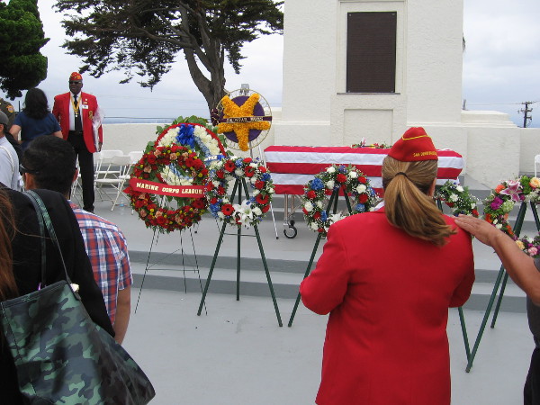 After the Memorial Day ceremony, some people linger to view the ceremonial wreaths. The plaque behind the rostrum contains President Lincoln's famed Gettysburg Address.