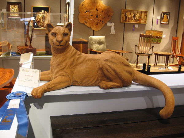 A mountain lion carved from wood keeps guard among other spectacular works of art. Kitty Kitty, Mahogany, Bill Churchill.