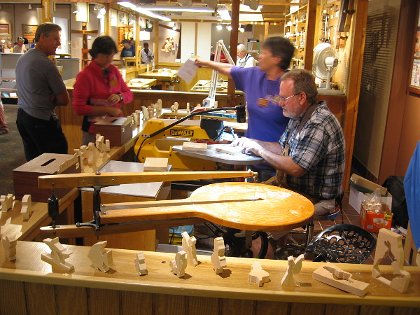Members of the San Diego Scrollsaw Clubs demonstrate their craft to people visiting the Design in Wood Exhibition at the San Diego County Fair.