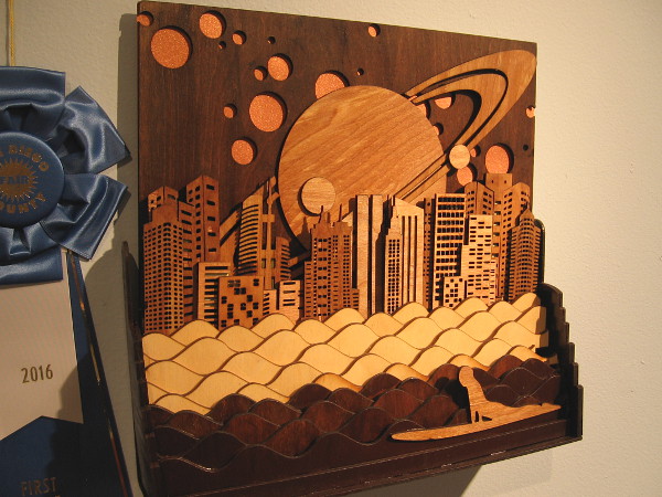 I love the cosmic layered wood sky with Saturn behind buildings. Night Surfing, Hardwood Plywood, Robert Stafford.
