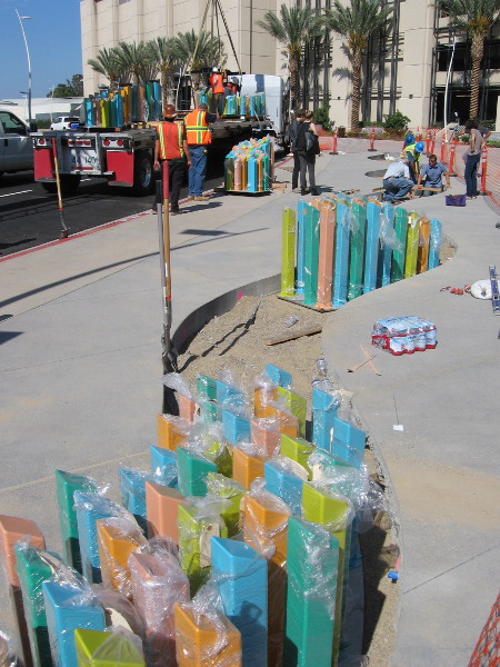 Looking along the wavy length of the colorful tide. The art seems to undulate like water.