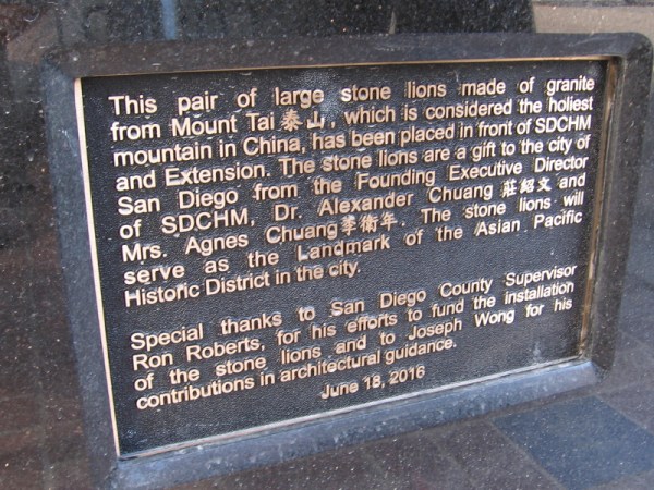 Plaque describes pair of large stone lions made of granite from Mount Tai, considered the holiest mountain in China. They will be a landmark of the Asian Pacific Historic District of San Diego.