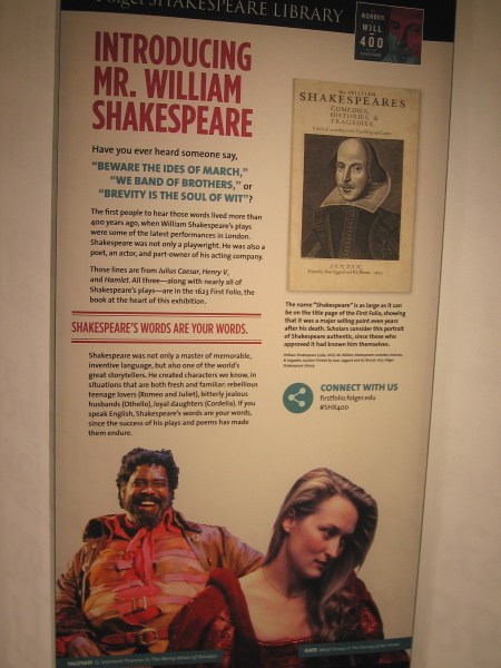 On either side of the displayed First Folio are several signs. The first one pictured introduces Shakespeare. His words are your words.