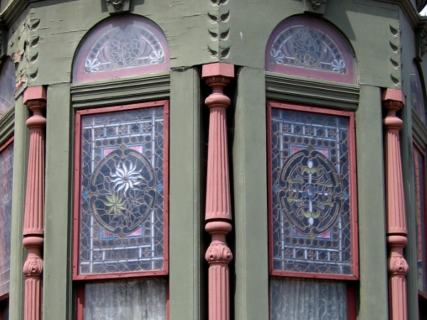 A light-filled chapel-like nook in one corner of Jesse Shepard's performance room features stained glass depicting the four seasons.