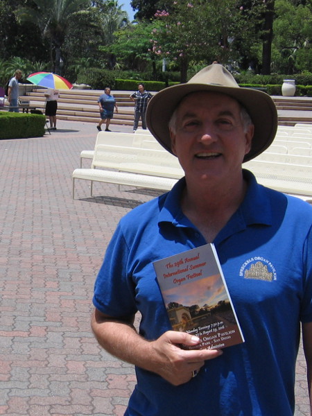 Ross Porter, Executive Administrator of the Spreckels Organ Society, shows us the newly printed program which visitors will receive at every free summer Monday night performance.