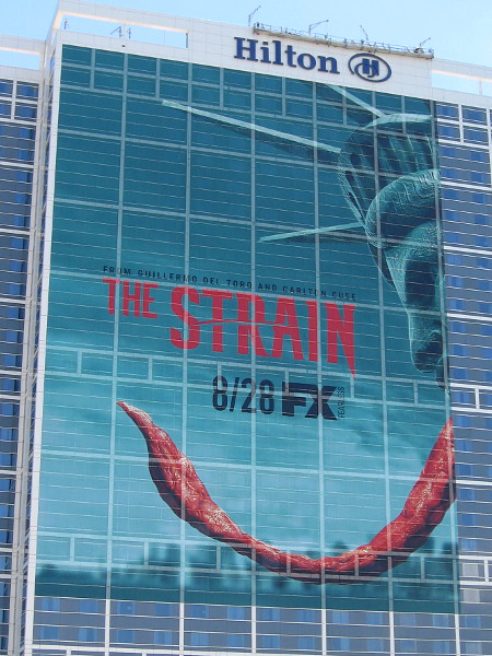 The Statue of Liberty has become a vampire. Either that, or it's not feeling very well. The Strain building wrap on the Hilton San Diego Bayfront is approaching completion.