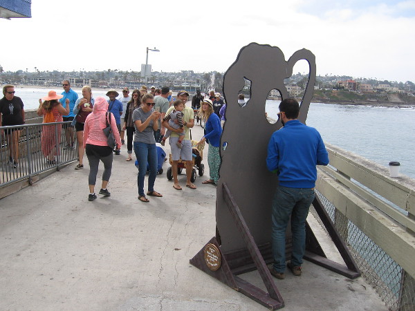 People were poking their heads through a couple of fun photo props, set up just for the special occasion.