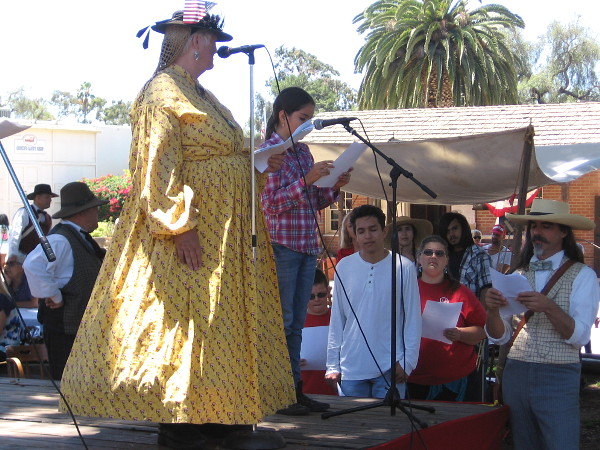 An ordinary American young person reads a few lines from the Declaration of Independence, on the Fourth of July in Old Town San Diego State Historic Park.