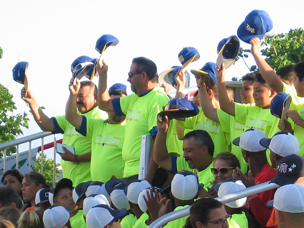 One of the teams from Tijuana, Mexico salutes the crowd by removing their caps.