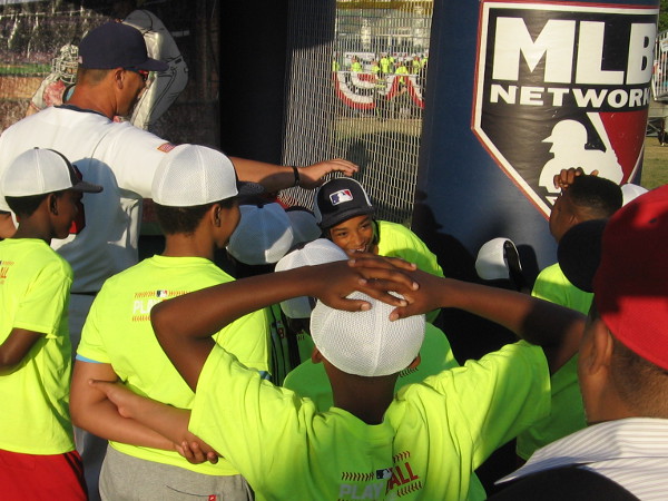 This kid nailed the strike zone with a great pitch. Everyone was having fun and simply enjoying good old baseball. It's summer. It's America's Pastime. What else does anyone need?
