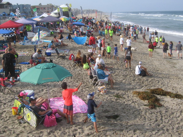 A crowd gathers on the beach in the morning, as the very popular Surf Dog Competition is almost ready to begin!