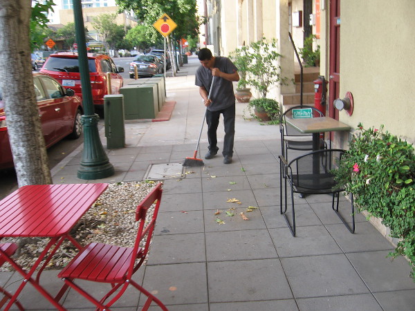 Sweeping up some leaves, preparing for another day.