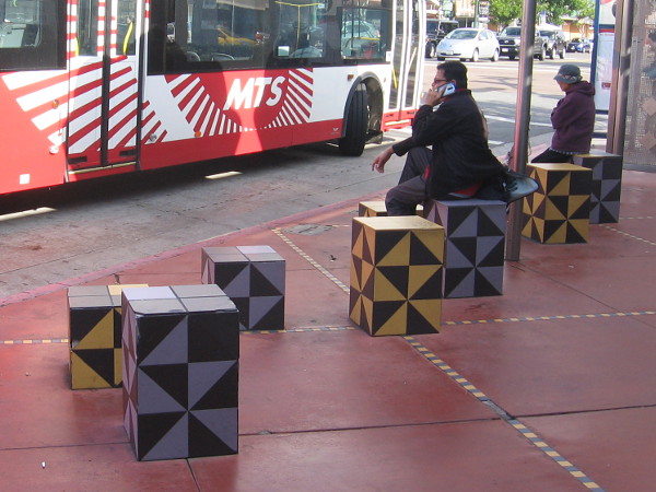 These artistic cubes are fun seats for people waiting for the bus.
