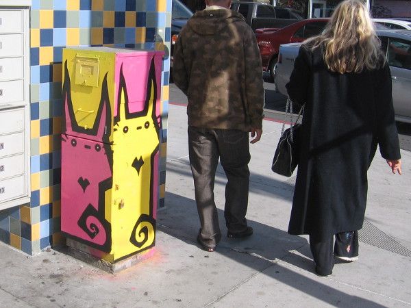 Turning a corner past pink and yellow cats.