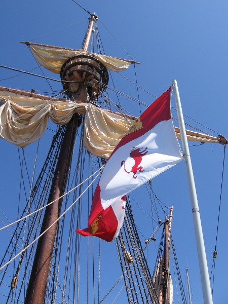 Looking up at masts, a crow's nest, and a flag of the Spanish Empire while waiting to board the San Salvador. This ship is an approximate replica of what Juan Rodriguez Cabrillo sailed in when he discovered San Diego Bay in 1542.