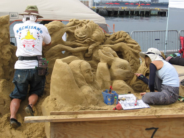 We're All Mad Here! It must be an Alice in Wonderland themed sand sculpture! I see a team member of Archisand.