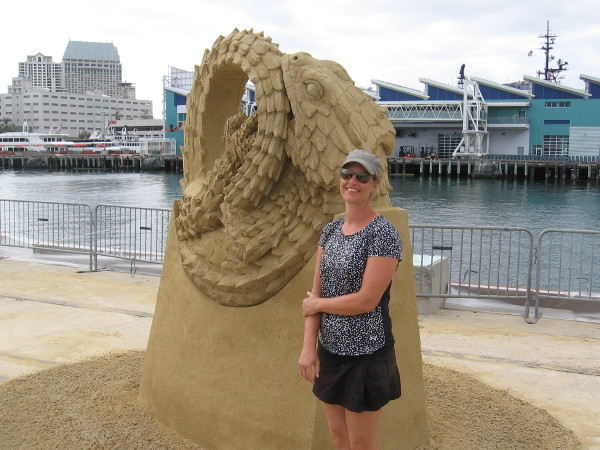 The friendly world-class sand sculptor Susanne Ruseler poses for photos by her fantastic artwork.