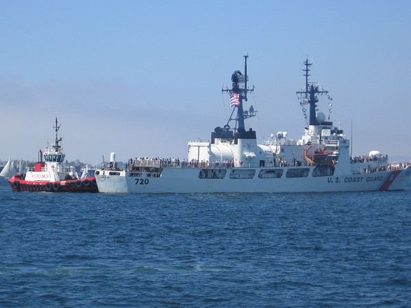The Coast Guard's USCGC Sherman endurance cutter is given a bit of assist by a tug boat as it comes into dock during the Sea and Air Parade.
