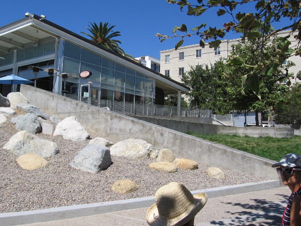 The audience takes a seat. Is something behind that wall?
