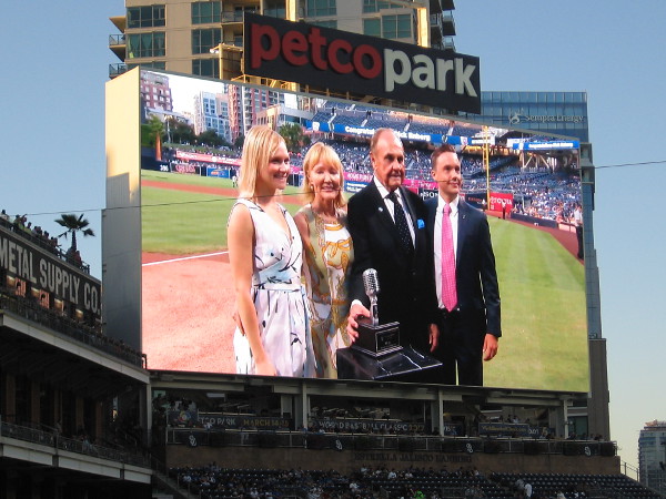 Dick Enberg receives honors during a ceremony on the field before his final home Padres ball game. Here he is seen with his family.