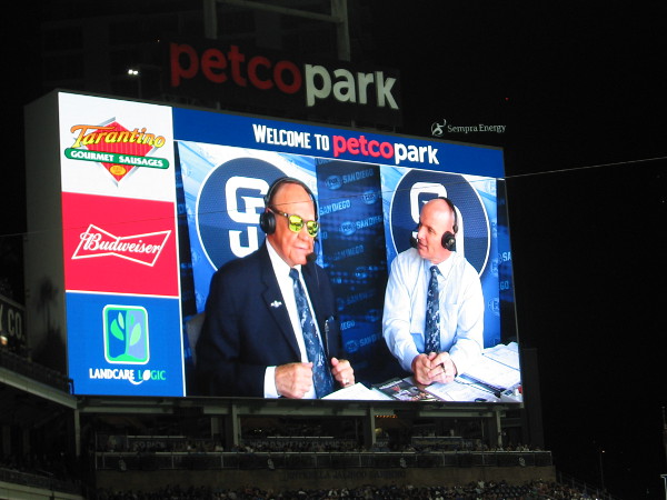 Dick Enberg sports cool sunglasses during a Padres baseball broadcast alongside Mark Grant.