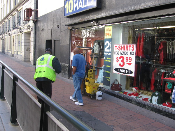 A scene of ordinary city life near the Fifth Avenue trolley station.