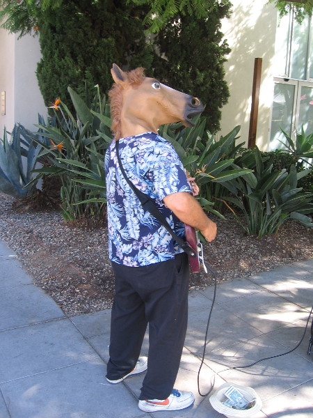 Entertainer with horse head at the Little Italy Farmers' Market.