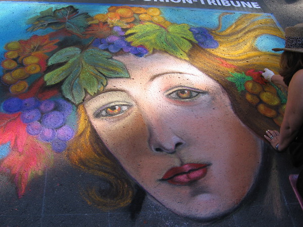 Renee Keady. Grapes crown a beautiful female face.