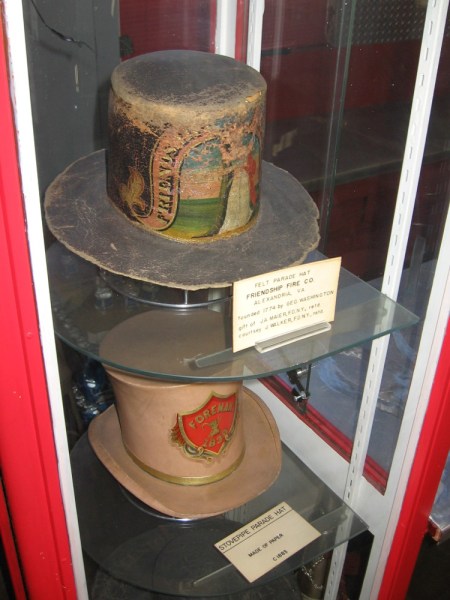 Felt and paper stovepipe hats once worn by firefighters during parades.