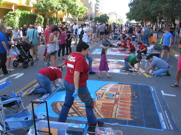 A crowd admires chalk art, or Gesso Italiano, during Festa. The amazing artwork celebrated Italy's history and culture.