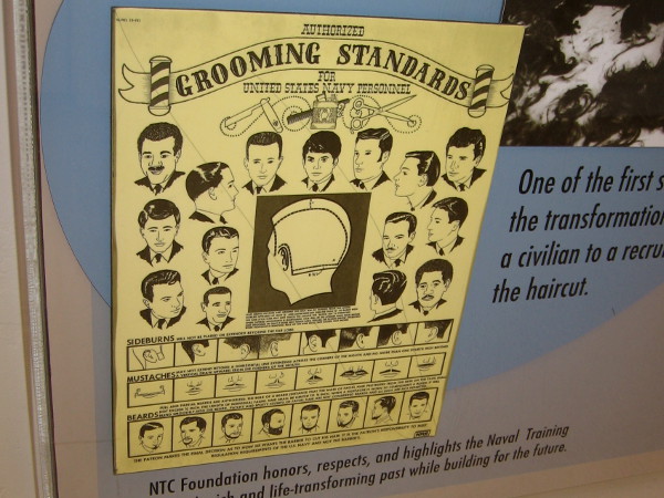 An old poster depicts authorized grooming standards for United States Navy Personnel.