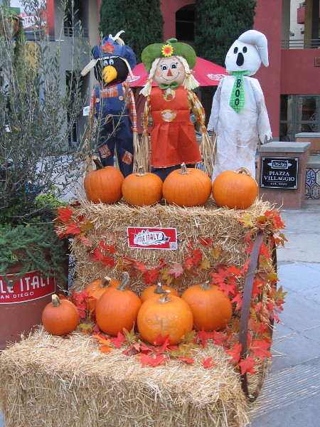 A fun display of pumpkins and Autumn characters on a street corner in Little Italy. Halloween is on the way! Boo!