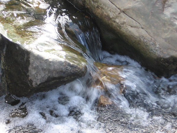 Water spills over rocks. It isn't Niagara Falls, but it is wonderful nonetheless.
