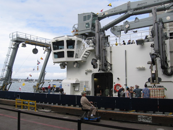 Photo aiming toward the stern of RV Sally Ride. The big A frame, giant crane, and two retractible arms on the starboard side of the ship are visible.