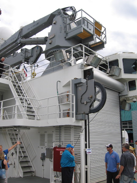 Turning a bit to the right, we see the big crane atop a staging bay that is sheltered from the weather. Inside, equipment can be carefully prepared before deployment out in the elements.