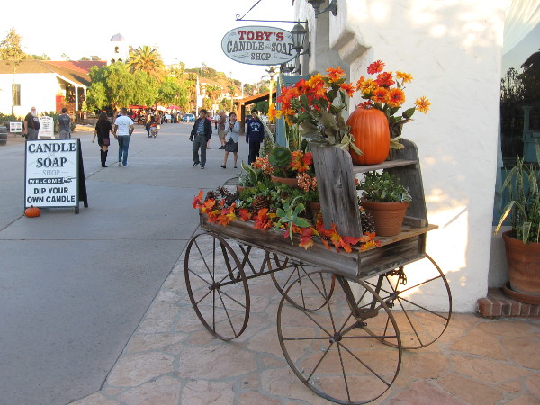 A pumpkin and warm flowers on an antique cart in Old Town San Diego.
