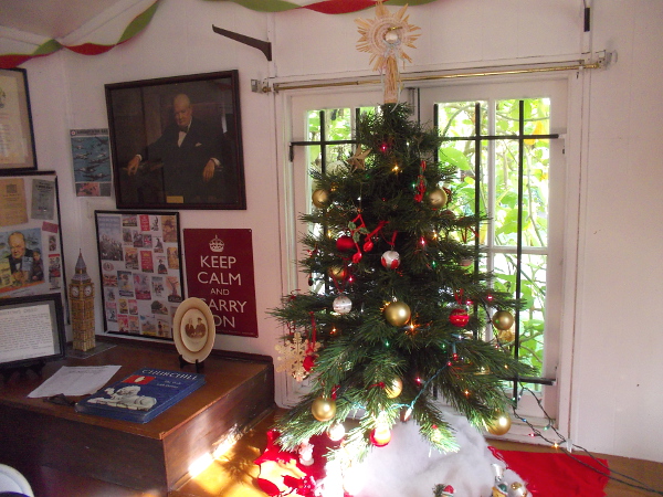 A small but cheerful Christmas tree inside the House of England.
