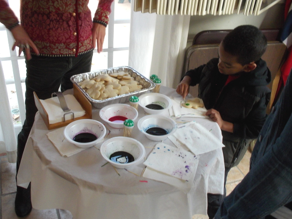 Adding color to Christmas cookies inside the House of Norway.