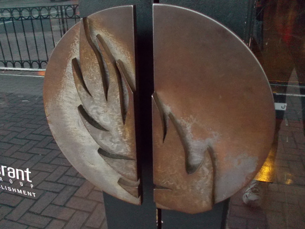 Interesting door handles together form a disk and leaf.