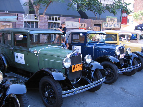 A row of shiny vintage cars on display during the popular downtown San Diego event.