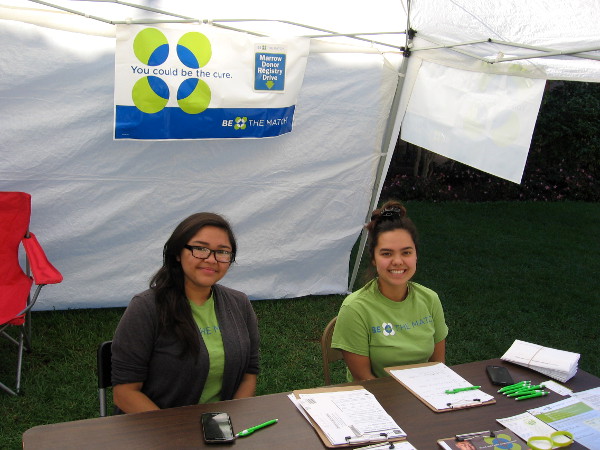 You could be the cure! Smiling ladies in Balboa Park register potential bone marrow donors. And there are other ways that you can fight cancer, too!