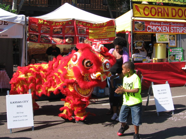 Fourth Avenue runs through San Diego's Chinatown, which is officially called the Asian Pacific Thematic Historic District. A colorful lion dancer turns heads at the Fall Back Festival.
