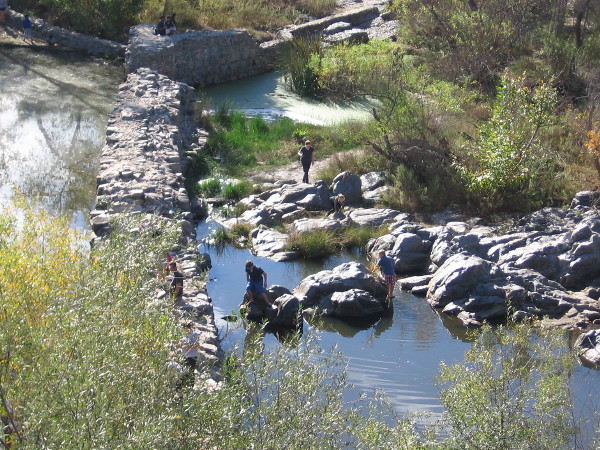 Families play on the rocks near the Old Mission Dam at Mission Trails Regional Park.